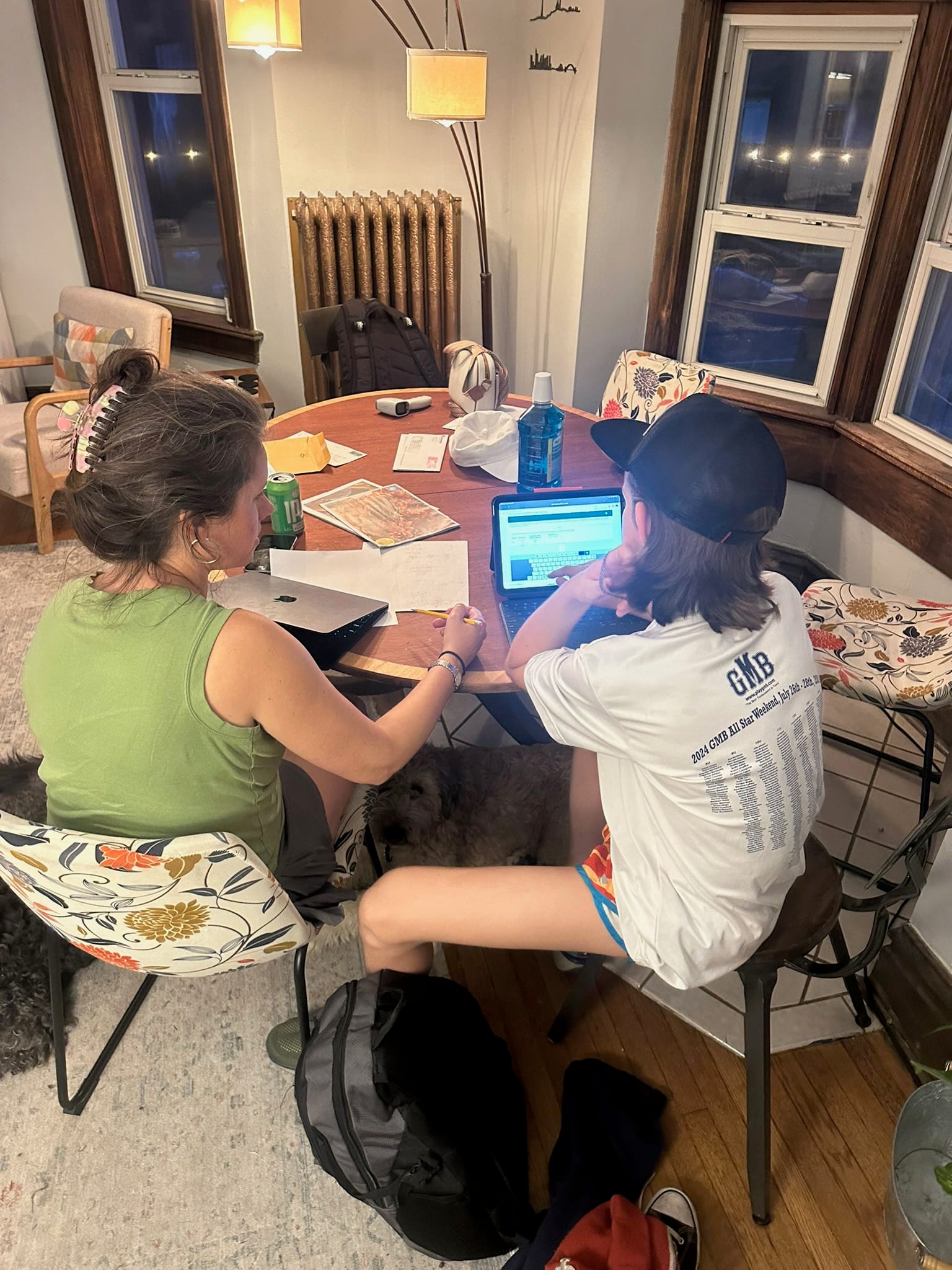 Homework at the table. The dog supervised.